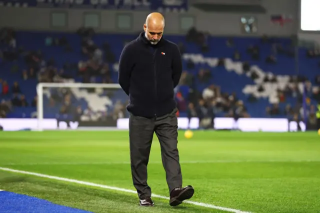 Guardiola strolls down the touchline deep in thought