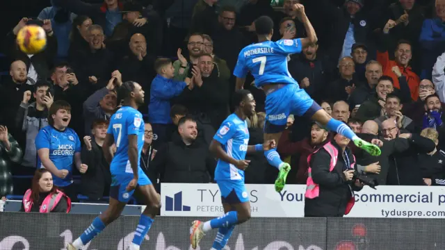 Peterborough's Malik Mothersille jumps for joy after converting a penalty against Cambridge