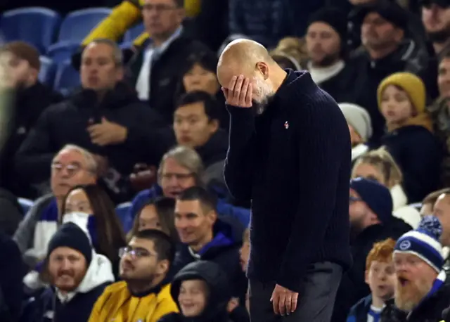 Guardiola covers his face with his hand