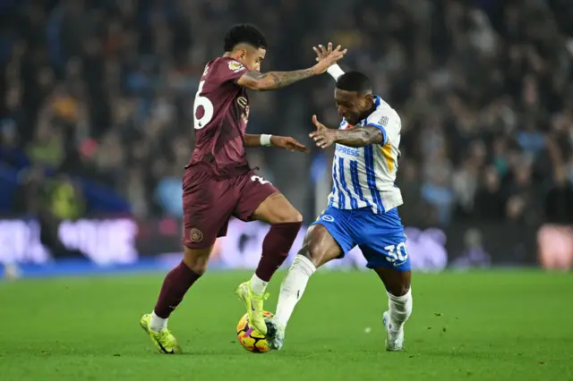 Savinho of Manchester City battles for possession with Pervis Estupinan of Brighton & Hove Albion.