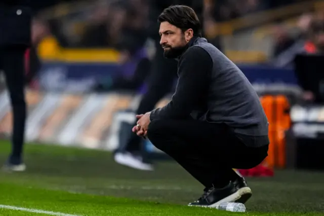 Russell Martin crouches in his technical area