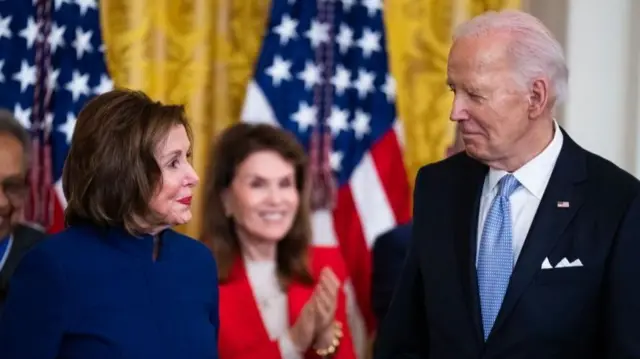 Nancy Pelosi and President Joe Biden lock eyes during a White House event