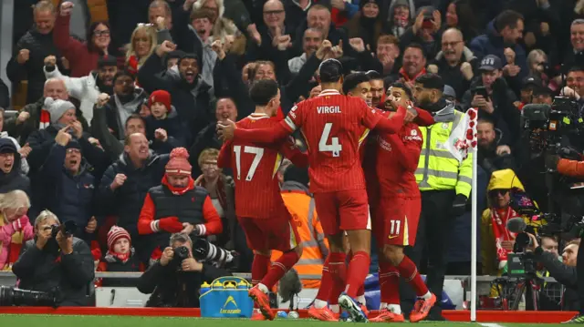 Liverpool players celebrate after taking the lead against Aston Villa