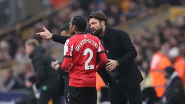 Southampton manager Russell Martin speaks with Kyle Walker-Peters.