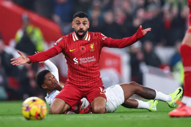 Mo Salah reacts after being taken down by Leon Bailey