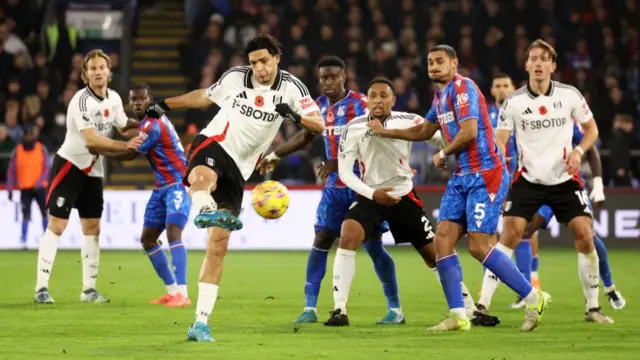 Raul Jimenez strikes at goal for Fulham.