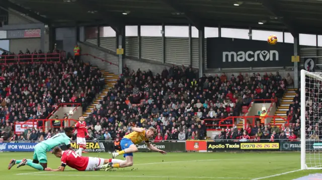 Wrexham goalkeeper Arthur Okonkwo thwarts Mansfield's Will Evans