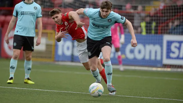 Cliftonville’s Micheal Glynn puts pressure on Larne forward Paul O’Neill