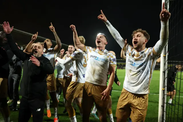 Players of Tamworth celebrate following their victory