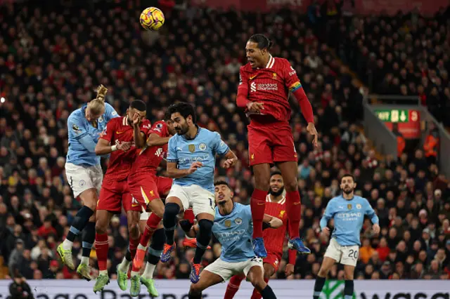 Virgil van Dijk jumps to head the ball.