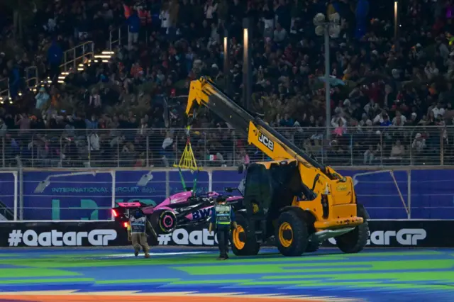 Race marshals remove Alpine's French driver Esteban Ocon's car