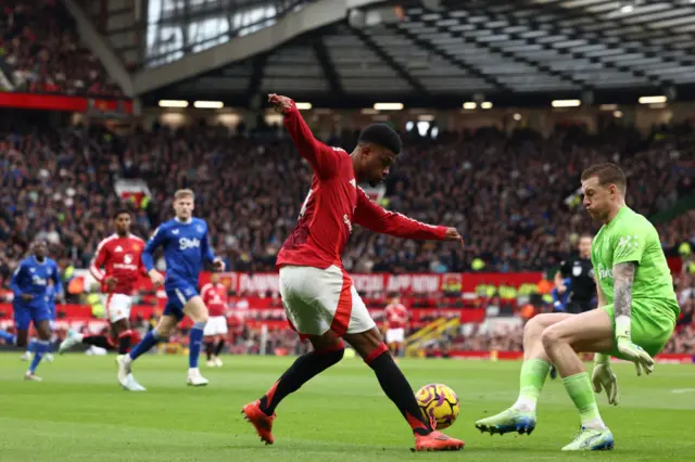 Amad Diallo's effort is blocked by Jordan Pickford