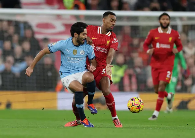 Manchester City's Ilkay Gundogan in action with Liverpool's Ryan Gravenberch.