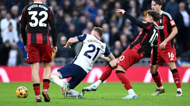 Fulham's Tom Cairney fouls Tottenham Hotspur's Dejan Kulusevski.