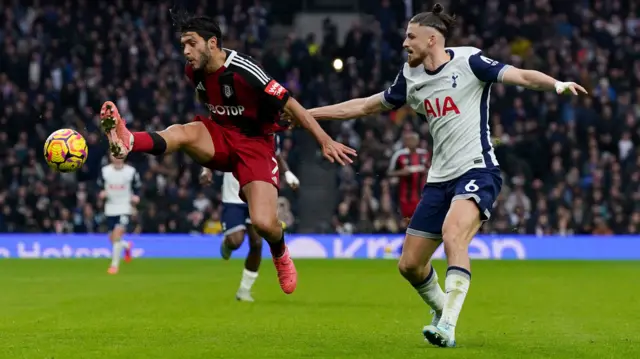 Fulham's Raul Jimenez (left) and Tottenham Hotspur's Radu Dragusin battle for the ball.