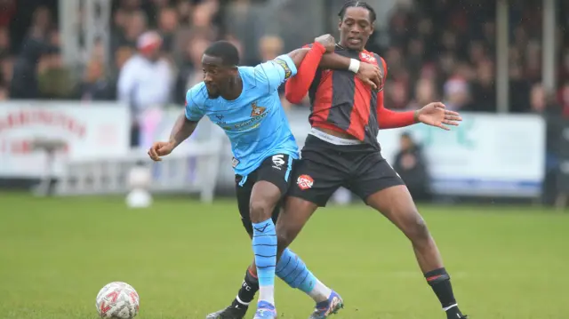 Nile Ranger of Kettering Town (R) tackles Joseph Olowu of Doncaster Rovers.