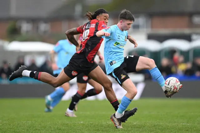 Patrick Kelly of Doncaster Rovers is challenged by Isiah Noel Williams of Kettering Town