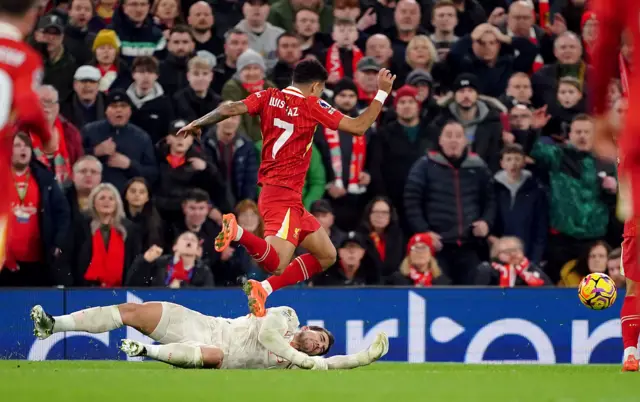 Manchester City goalkeeper Stefan Ortega brings down Liverpool's Luis Diaz to concede a penalty.