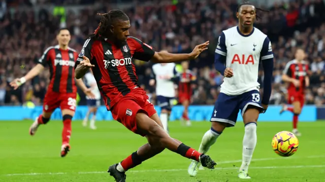 Fulham's Alex Iwobi shoots at goal and hits the crossbar.