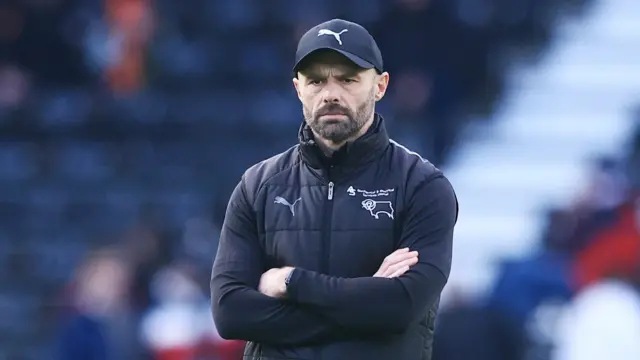 Derby County boss Paul Warne watches his players warm up