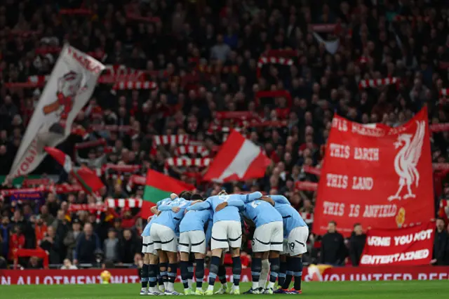 City players prepare in front of Liverpool fans ahead of kick-off.