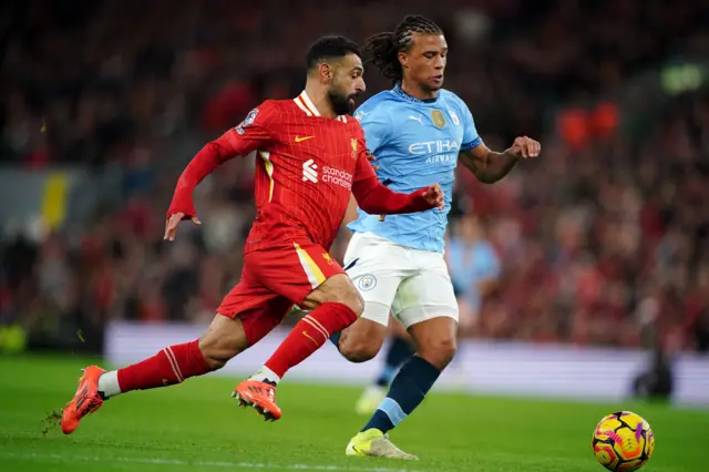 Liverpool's Mohamed Salah and Manchester City's Nathan Ake (right) battle for the ball.