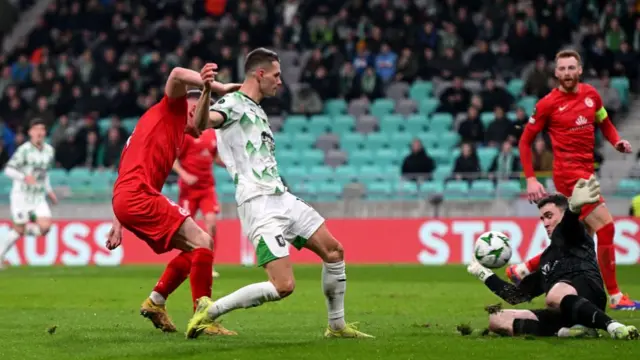 Raul Florucz sees his shot saved by outstretched Larne keeper Rohan Ferguson