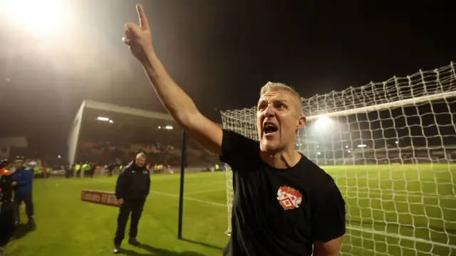 Kettering manager Richard Lavery celebrates beating Northampton Town