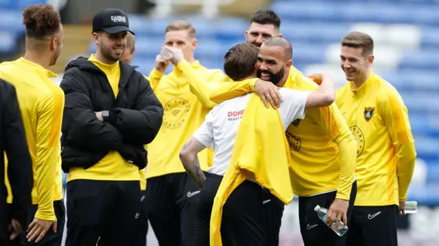 Sandro of Harborough Town with fellow players and officials before the game