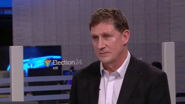 Eamon Ryan in the RTÉ studio he is wearing a black blazer and white shirt