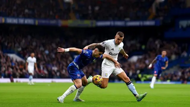 Pedro Neto of Chelsea FC and Lucas Digne battle for the ball