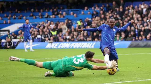 Nicolas Jackson of Chelsea has a shot saved by Emiliano Martinez