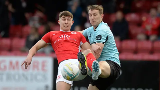 Larne’s Paul O’Neill and Cliftonville defender Jonathan Addis tussle for the ball