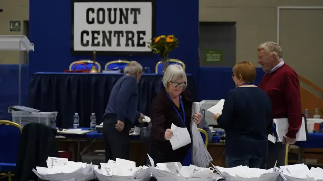 People sorting papers at a count centre for the Irish general election