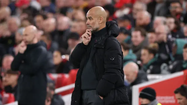 Man City manager Pep Guardiola looks on