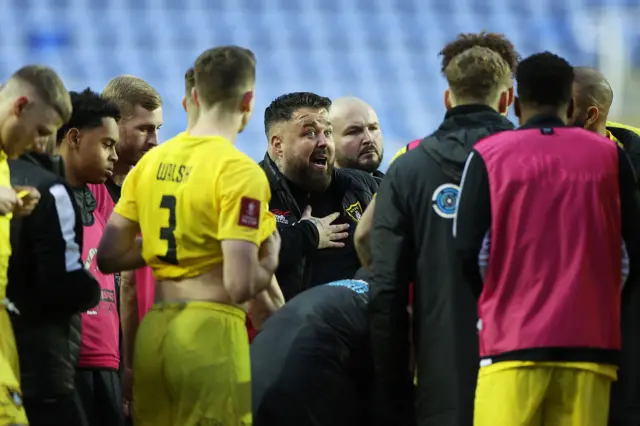 Mitch Austin, Manager of Harborough Town gives the team instructions