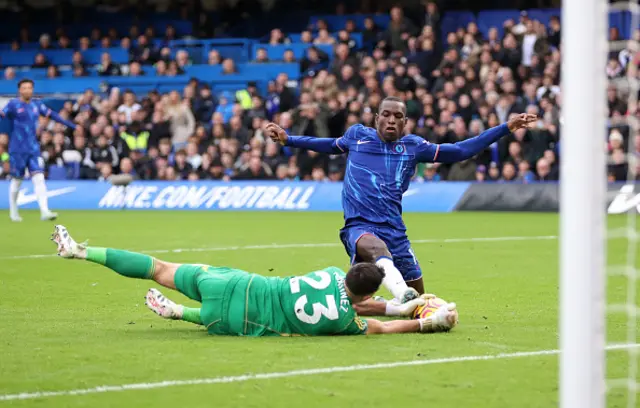 Nicolas Jackson of Chelsea has a shot saved by Emiliano Martinez