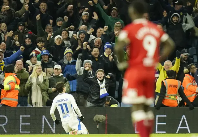 Brenden Aaronson knee slides in front of the Leeds fans