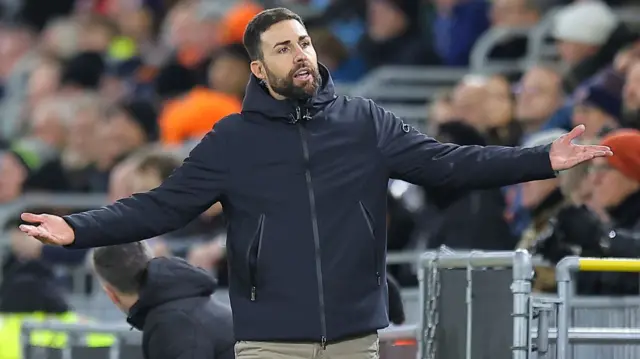 Stoke manager Narcis Pelach with his arms outstretched