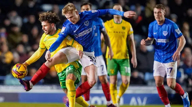 Portsmouth Paddy Lane tackles Norwich City midfielder Emiliano Marcondes