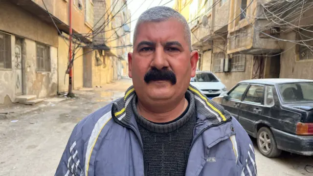 Tawfiq standing on a street in Ghouta