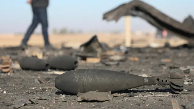 Mortars lie on the ground, near Qamishli International Airport