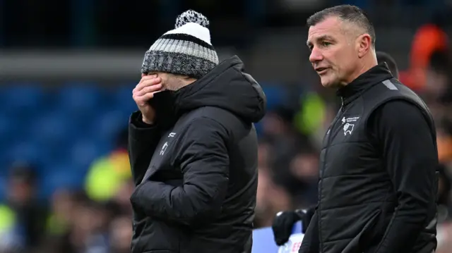 Paul Warne covers his face while watching Derby County