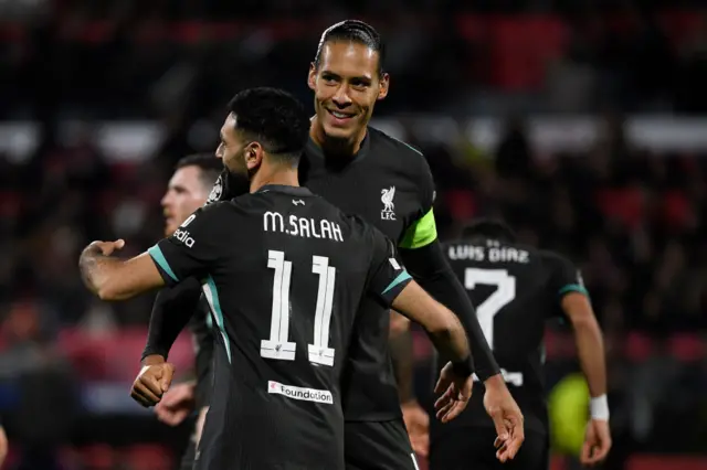 Mohamed Salah celebrates scoring the opening goal with Virgil van Dijk