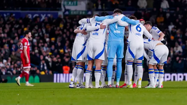 Leeds players huddle before kick-off against Middlesbrough