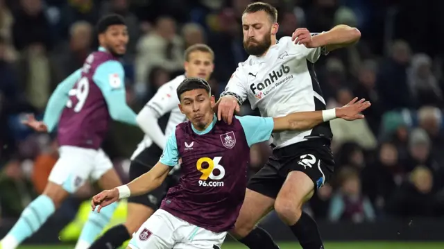 Burnley's Jeremy Sarmiento is challenge by Derby defender Nat Phillips