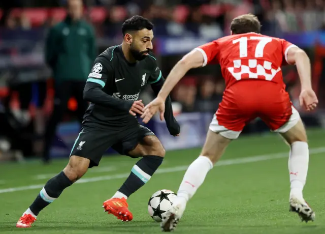 Mohamed Salah (left) and Girona's Daley Blind battle for the ball