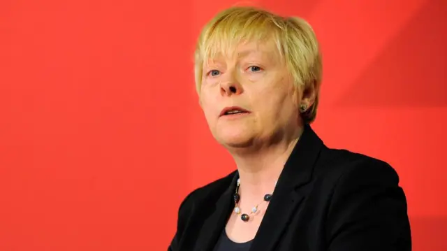 Close-up of Angela Eagle set against a red background