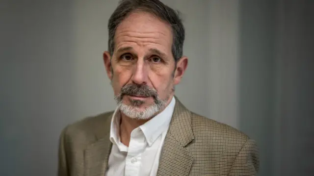 Robert Petit poses during an interview with AFP in Geneva