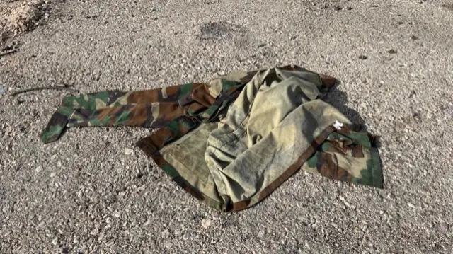 Discarded military uniform on ground